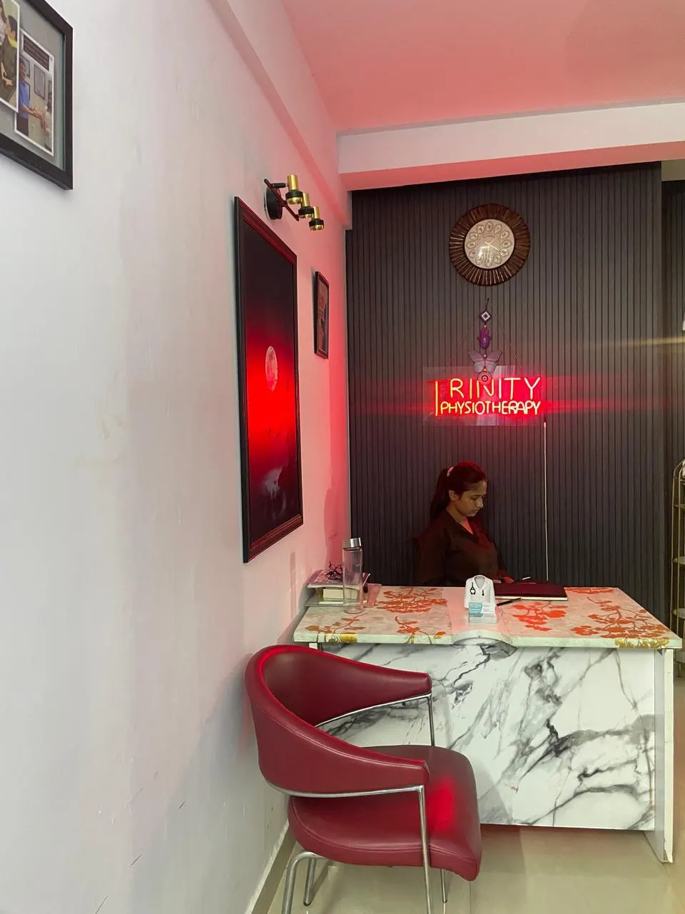 Trinity Physiotherapy reception with illuminated clinic sign